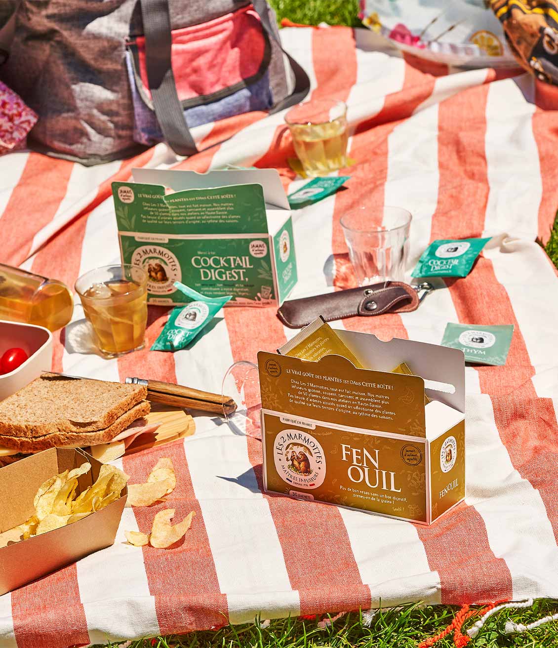 Boite Fenouil et Cocktail Digest sur une serviette de plage avec picnic